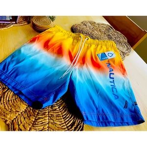 NAUTICA PERFORMANCE SWIM TRUNKS.
